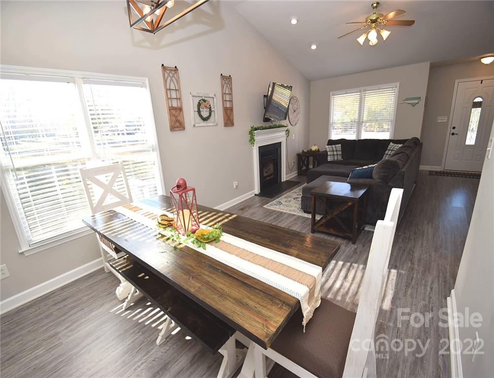 1909 Fletcher Broome Road, Unit 7 Monroe, NC 28112 - Photo 6 of 25 a living room with furniture a dining table and a chandelier