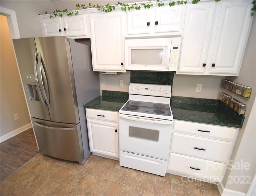 1909 Fletcher Broome Road, Unit 7 Monroe, NC 28112 - Photo 8 of 25 a kitchen with appliances and cabinets