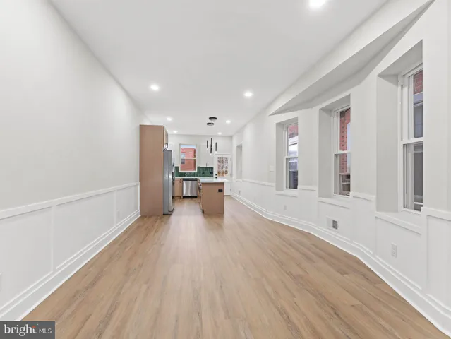 a view of kitchen and hall with wooden floor