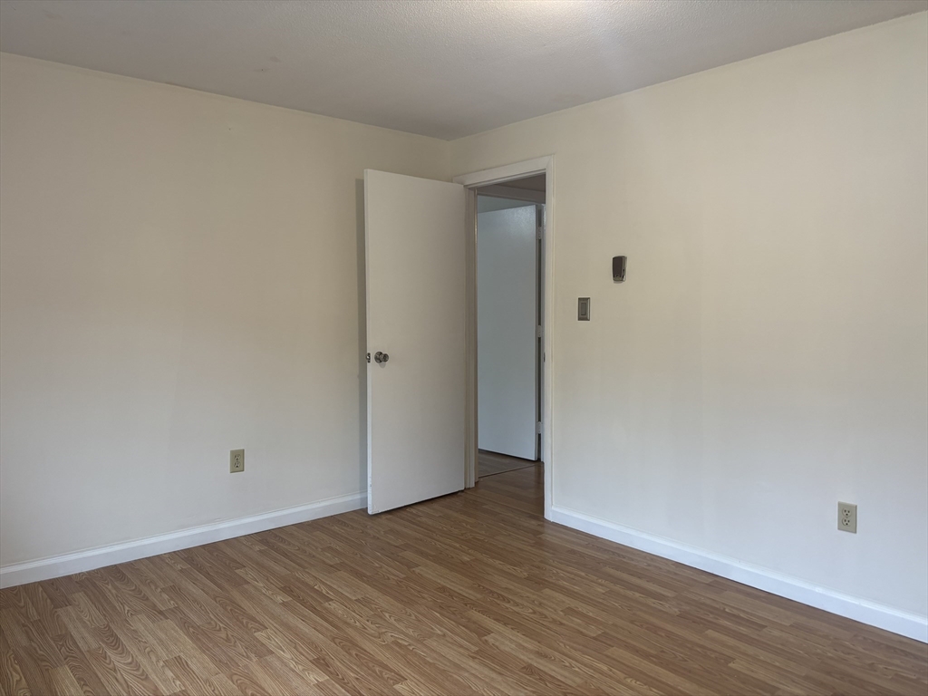 14 B Mayberry Drive, Unit 6 Westborough, MA 01581 - Photo 6 of 12 a view of an empty room with wooden floor
