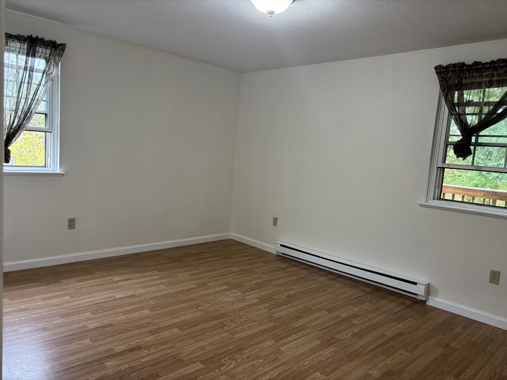 14 B Mayberry Drive, Unit 6 Westborough, MA 01581 - Photo 8 of 12 an empty room with window and wooden floor