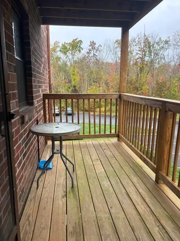 a view of balcony with wooden floor