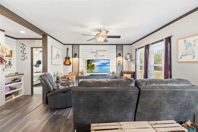 a kitchen with stainless steel appliances white cabinets and wooden floor