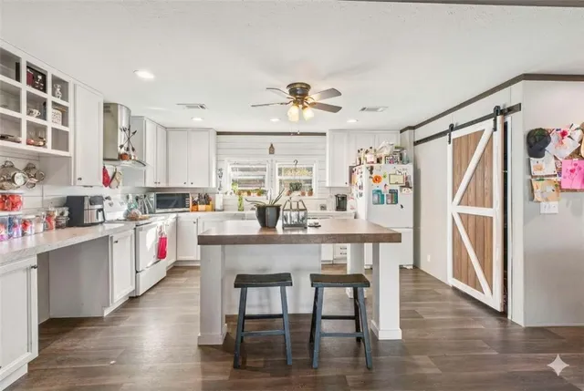 a kitchen with white cabinets and white appliances