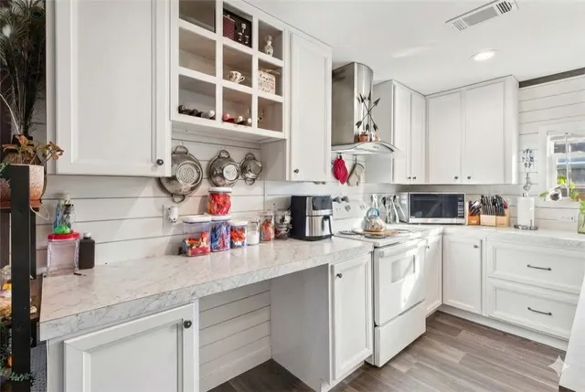 a kitchen with white cabinets and white appliances