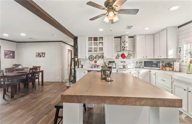 a view of a dining room with furniture wooden floor and next to a window