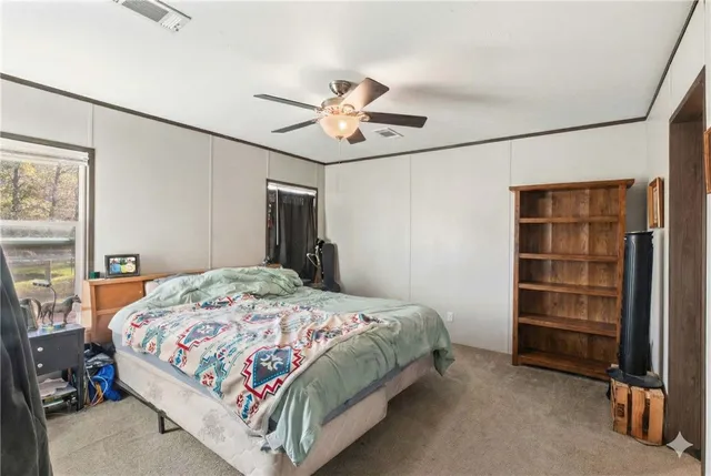 a view of a bathroom with sink mirror and shower