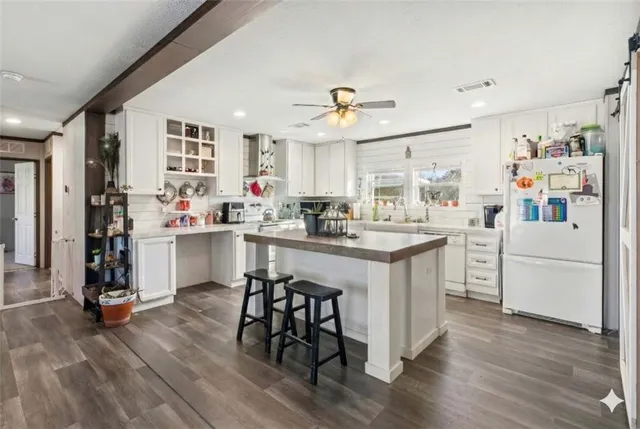 a kitchen with a sink cabinets and wooden floor