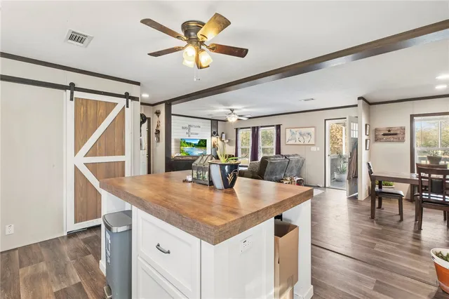 a view of dining table a sink and dishwasher with wooden floor