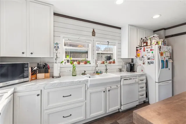 a view of cabinets a sink and a window in a room