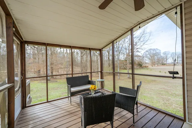 a view of a house with backyard and trees