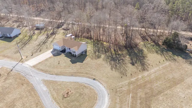 a view of a house with pool and sitting area
