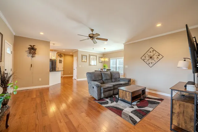 a living room with furniture and wooden floor