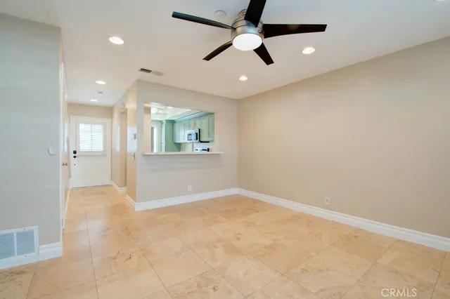 an empty room with a empty space and a ceiling fan