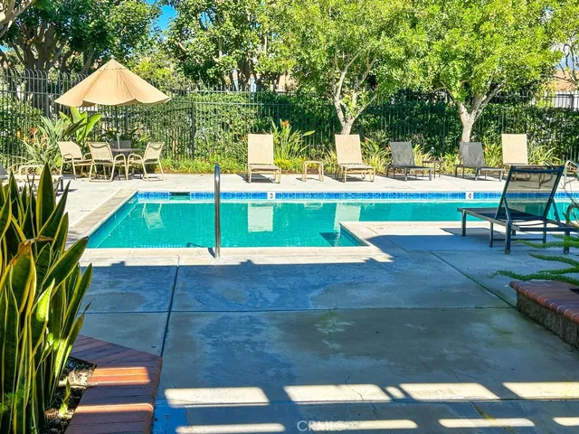 a view of yard with swimming pool and trees