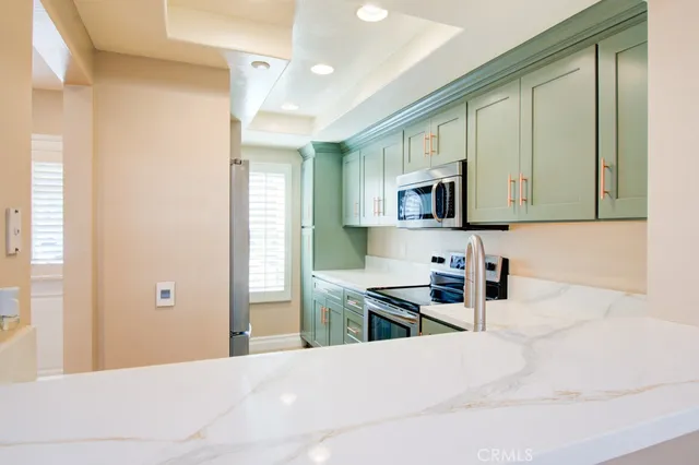a kitchen with granite countertop a stove and a wooden floor