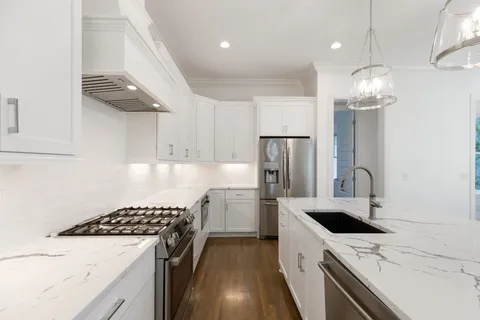a kitchen with a sink a stove and refrigerator