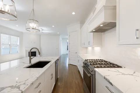 a kitchen with kitchen island a sink stainless steel appliances and cabinets