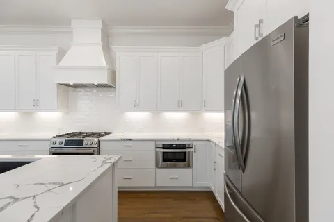 a kitchen with a stove and a refrigerator