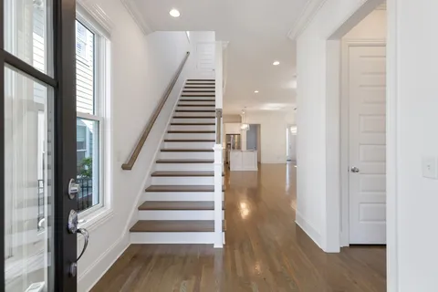 a view of a hallway with wooden floor and entryway