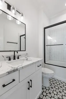 a bathroom with a sink toilet and mirror