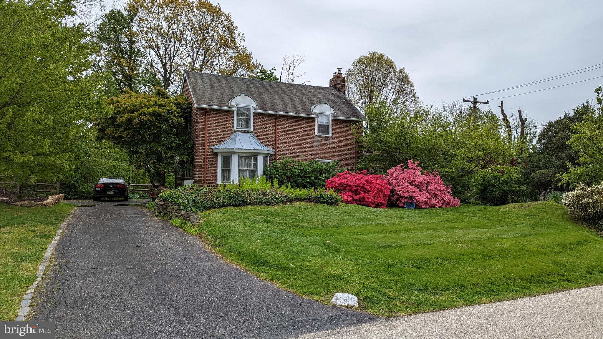 2 Green Valley Road Wallingford, PA 19086 - Photo 2 of 35 a front view of a house with a yard