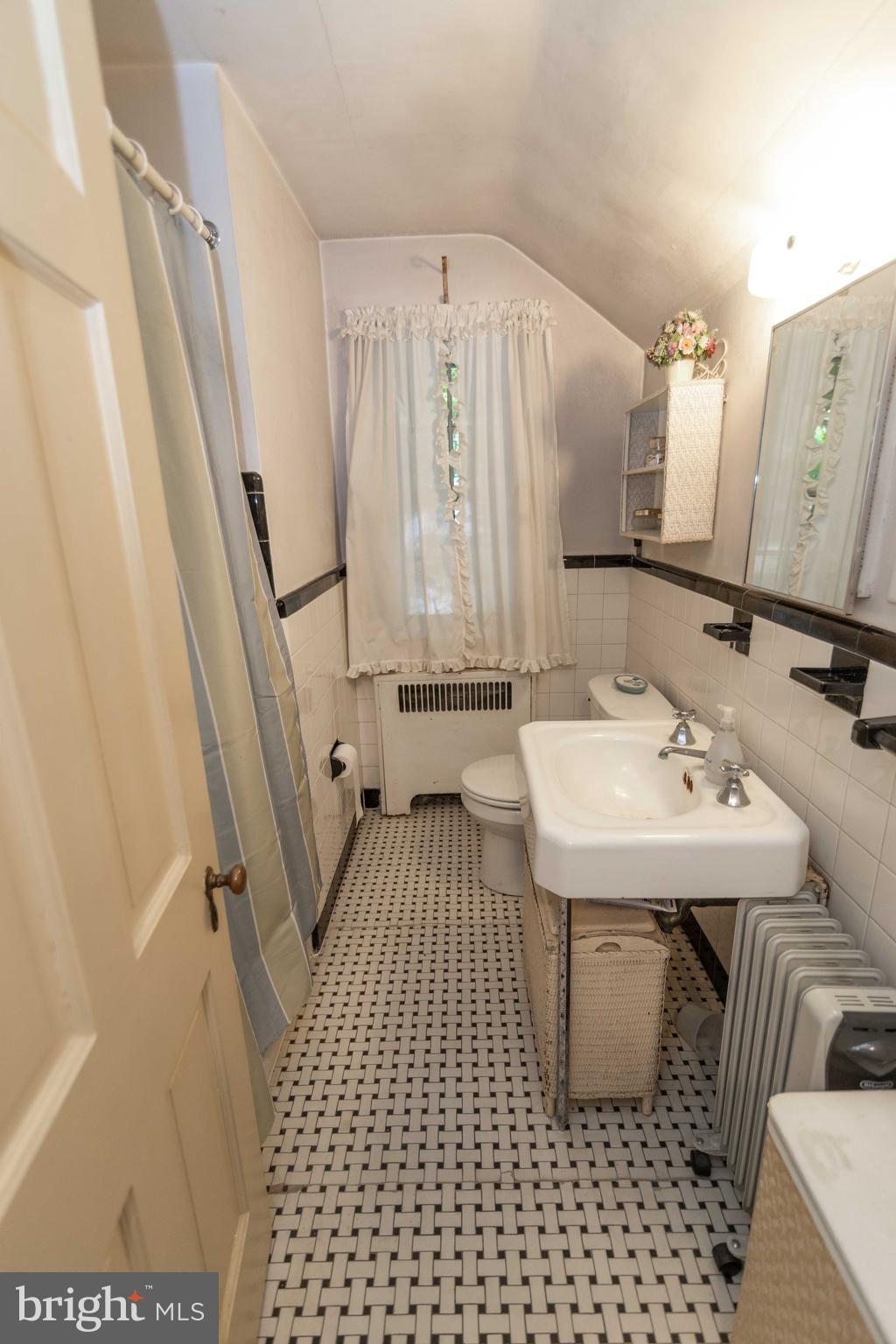 2 Green Valley Road Wallingford, PA 19086 - Photo 25 of 35 a bathroom with a sink a mirror and a shower
