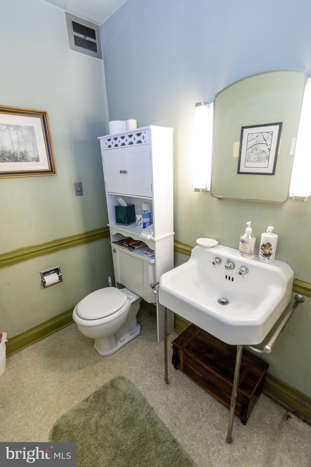 2 Green Valley Road Wallingford, PA 19086 - Photo 30 of 35 a bathroom with a sink a toilet and a mirror