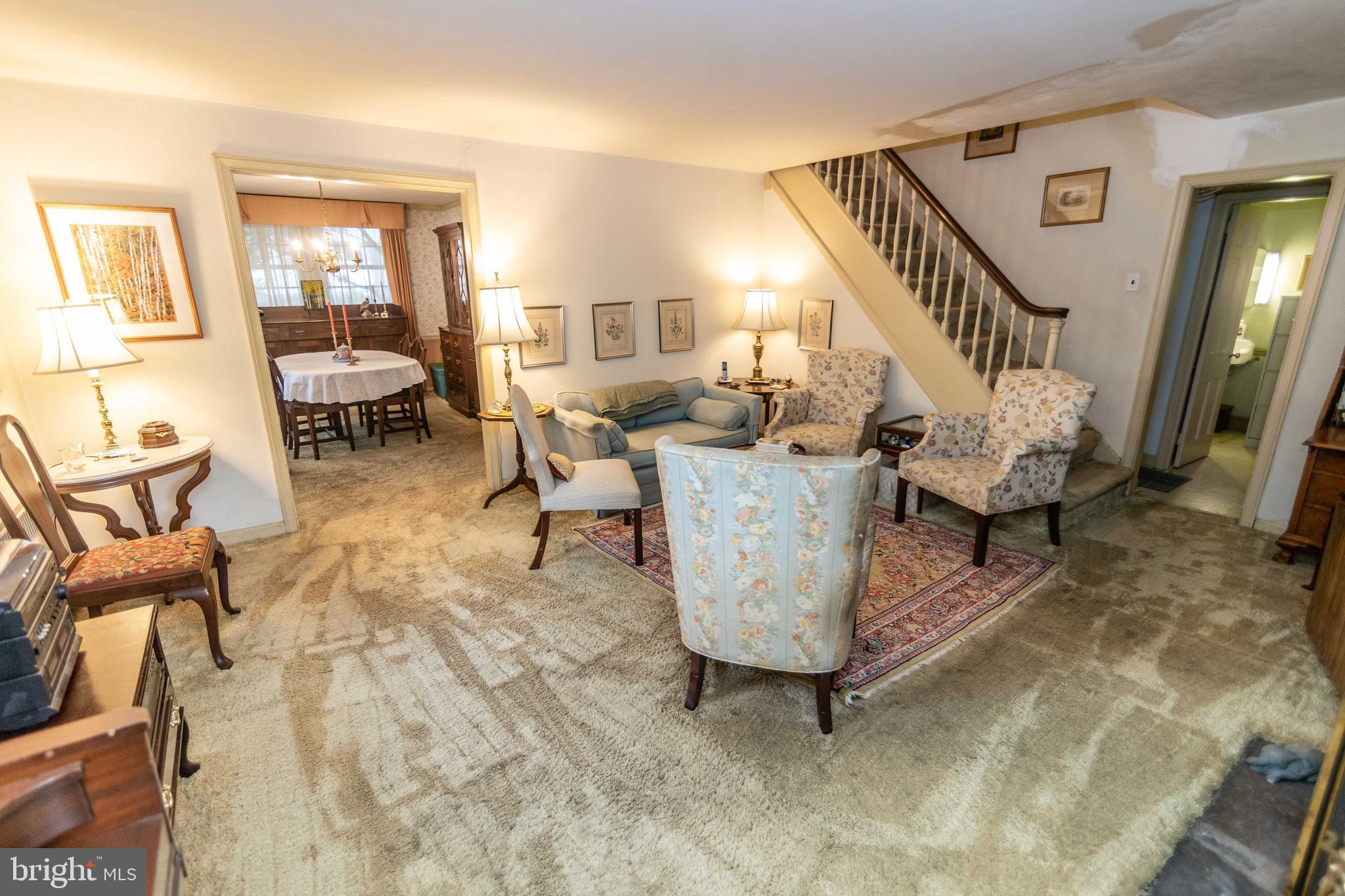 2 Green Valley Road Wallingford, PA 19086 - Photo 6 of 35 a living room with couches and a dining table with wooden floor