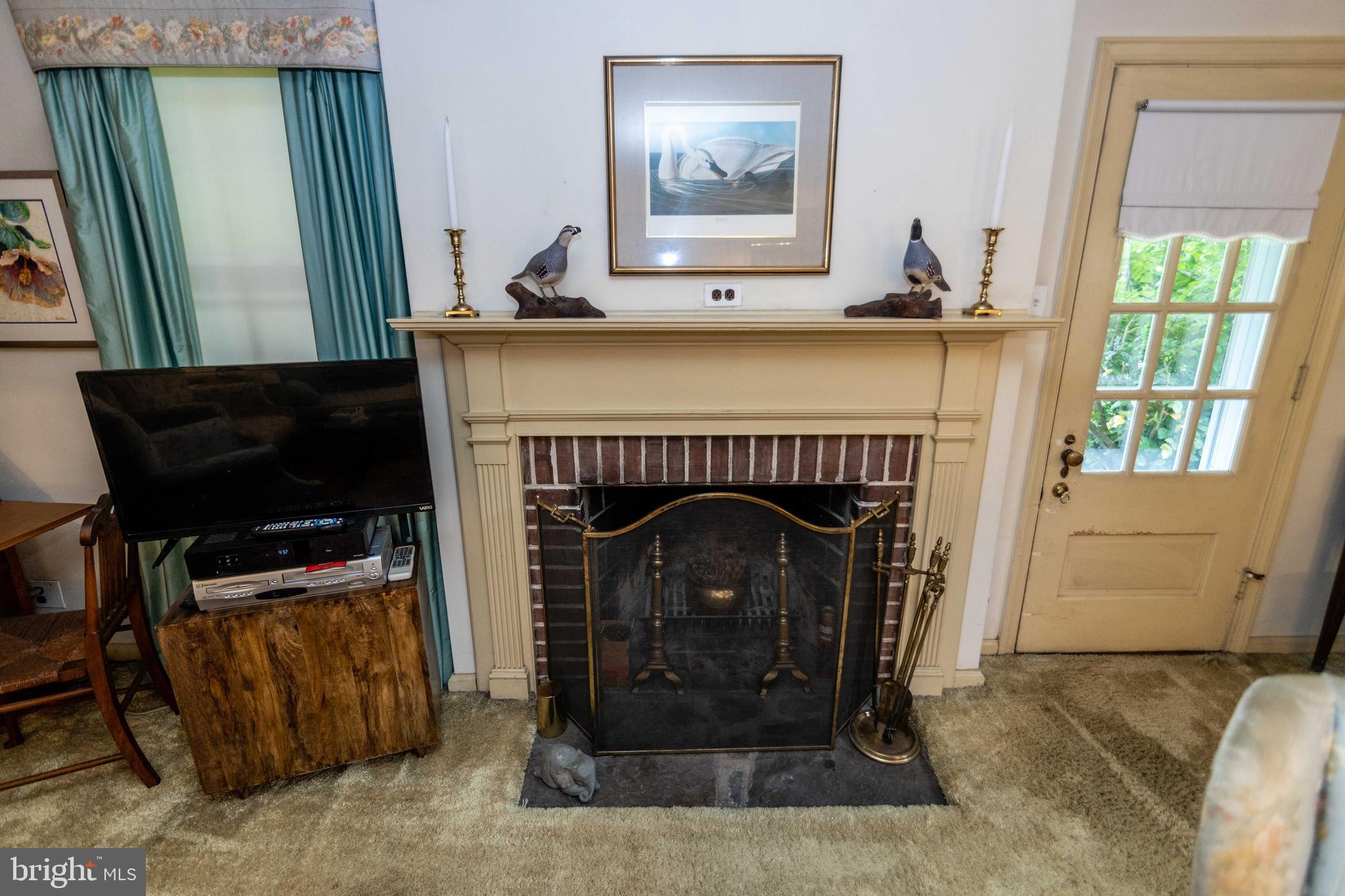 2 Green Valley Road Wallingford, PA 19086 - Photo 8 of 35 a living room with furniture and a fireplace
