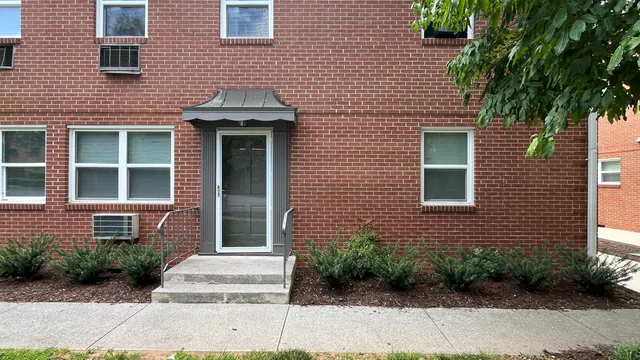 a brick house with a large windows