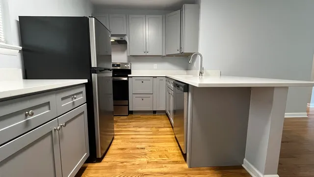 a kitchen with stainless steel appliances granite countertop a refrigerator and a sink