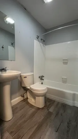 a bathroom with a toilet a sink and bathtub