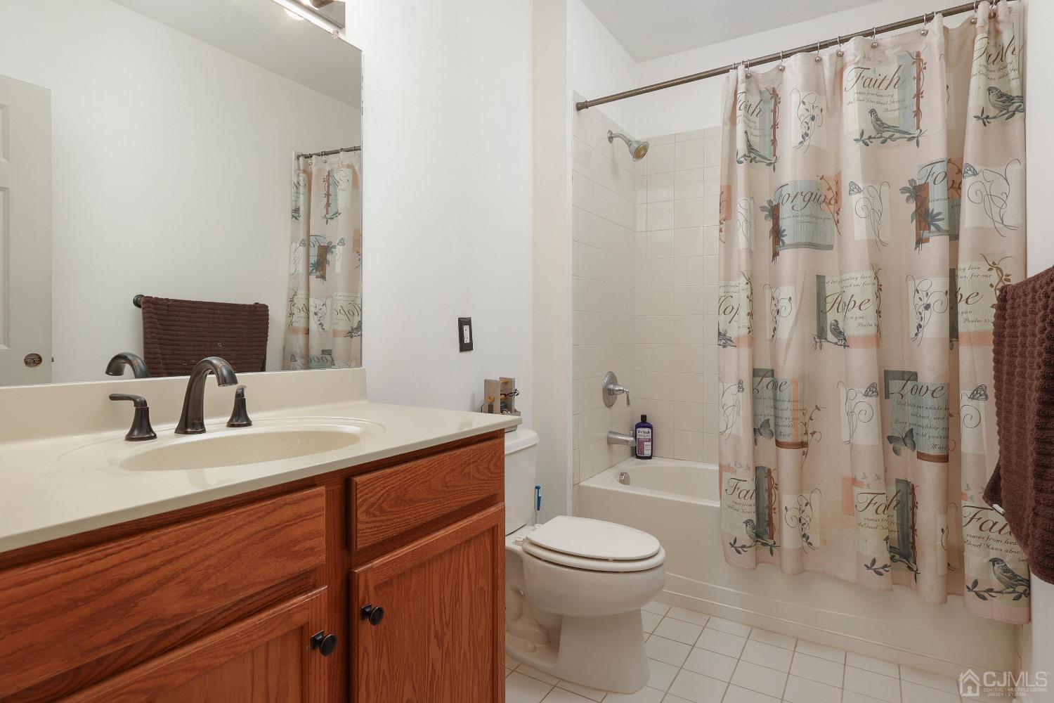 368 Rector Street, Unit 417 Perth Amboy, NJ 08861 - Photo 12 of 27 a bathroom with a granite countertop sink a toilet and shower