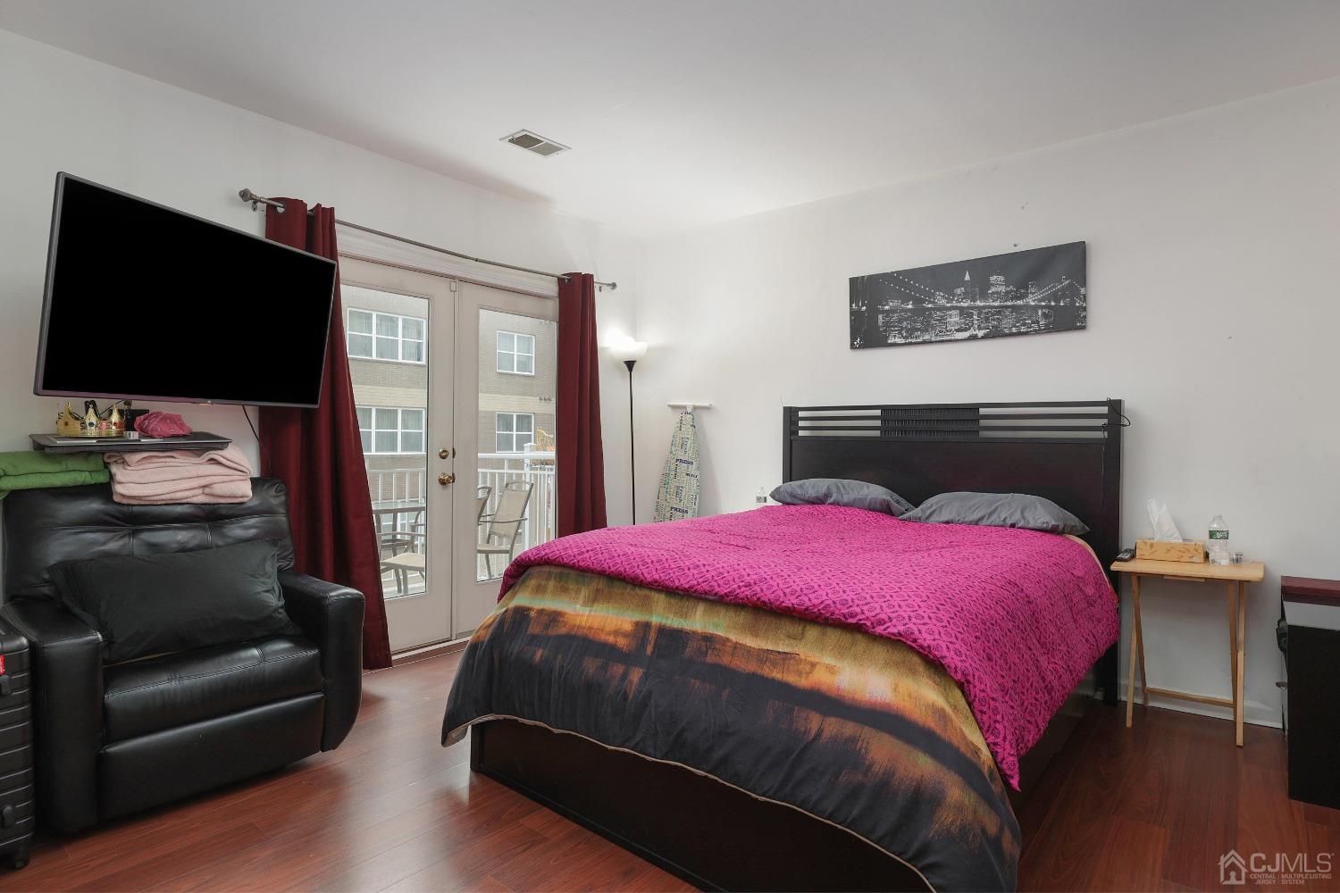 368 Rector Street, Unit 417 Perth Amboy, NJ 08861 - Photo 13 of 27 a bedroom with a bed and a flat screen tv