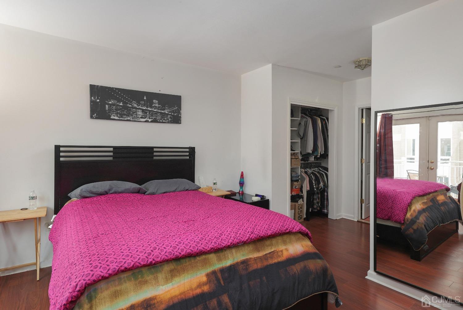 368 Rector Street, Unit 417 Perth Amboy, NJ 08861 - Photo 14 of 27 a bedroom with a bed and a mirror