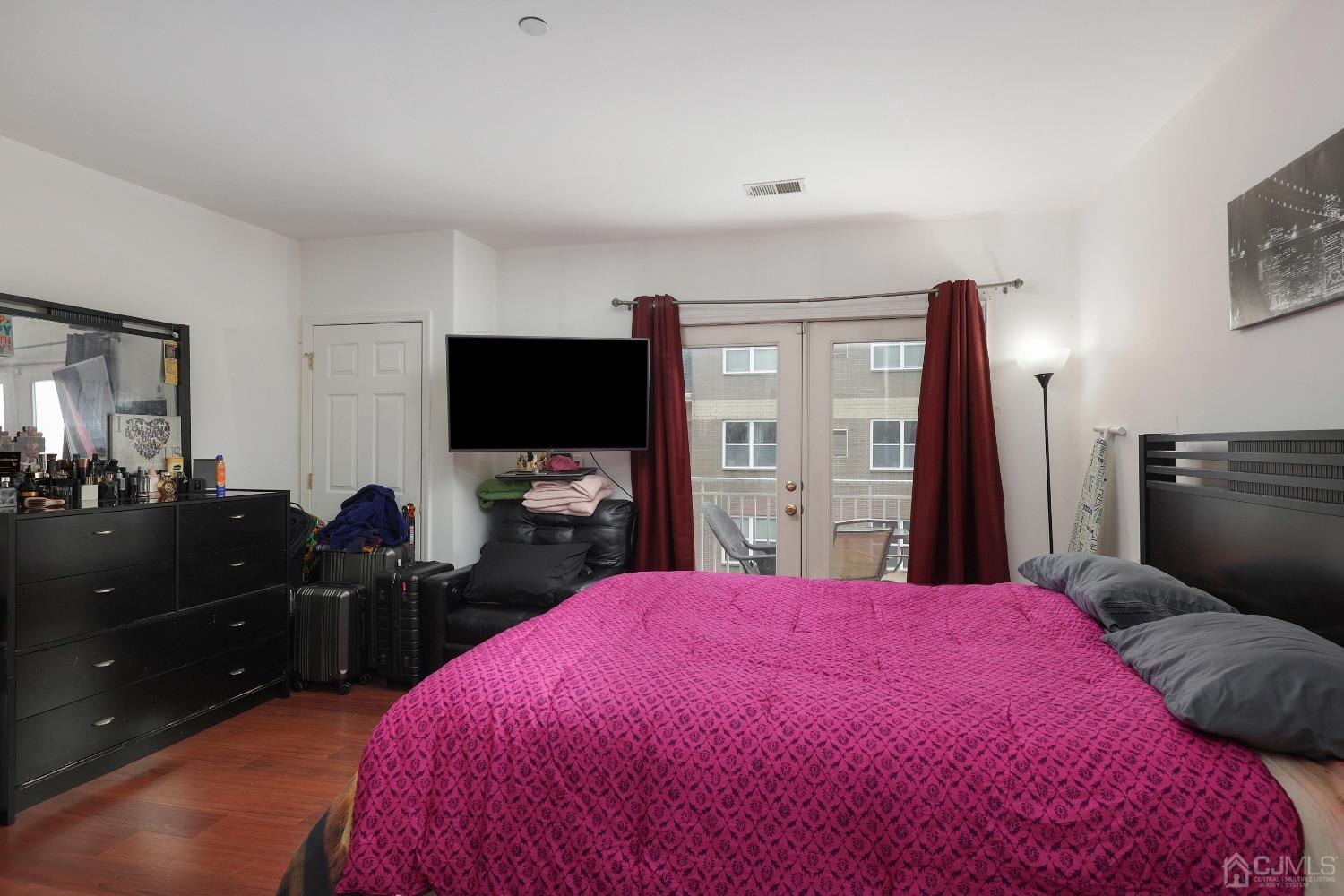 368 Rector Street, Unit 417 Perth Amboy, NJ 08861 - Photo 15 of 27 a bed room with a bed and a television