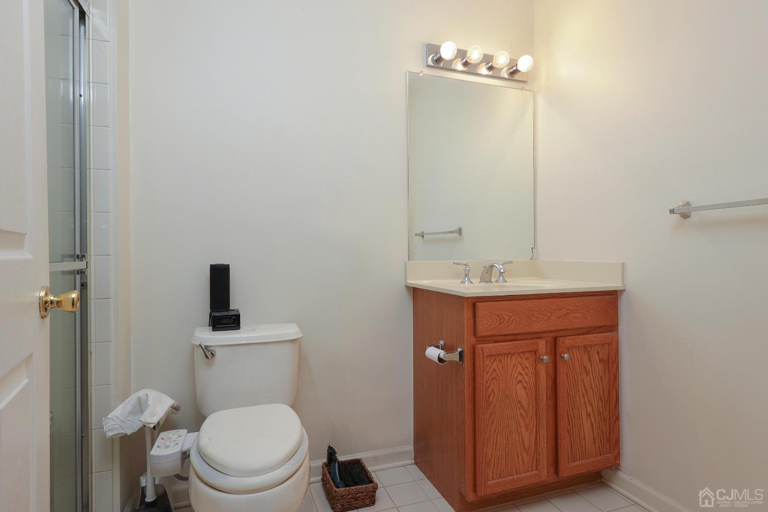 368 Rector Street, Unit 417 Perth Amboy, NJ 08861 - Photo 16 of 27 a bathroom with a toilet sink vanity and mirror