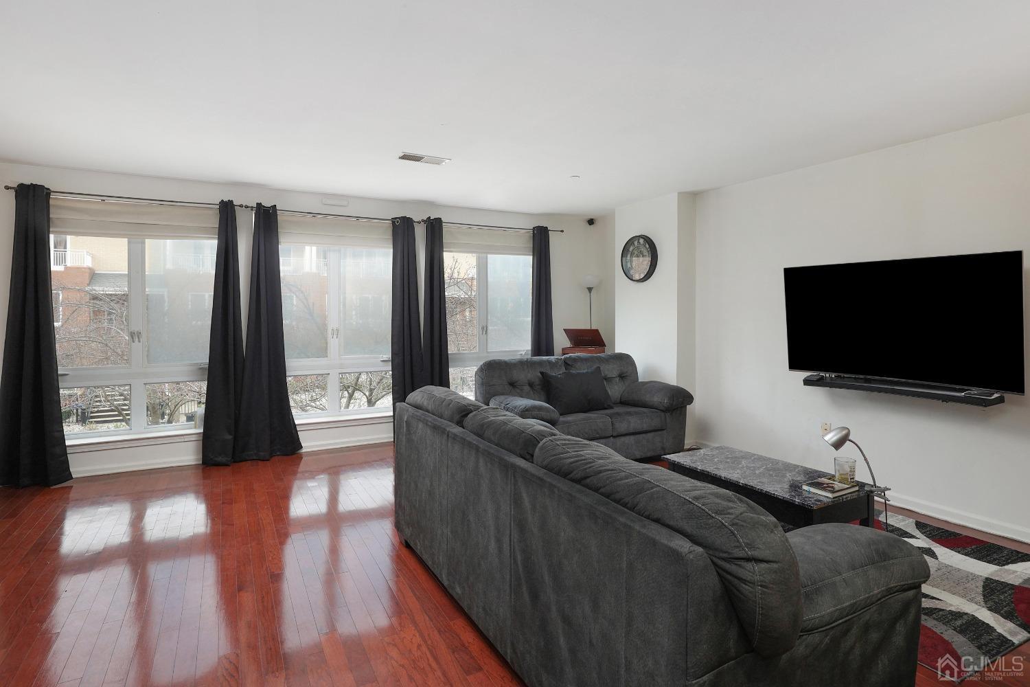 368 Rector Street, Unit 417 Perth Amboy, NJ 08861 - Photo 6 of 27 a living room with furniture and a flat screen tv