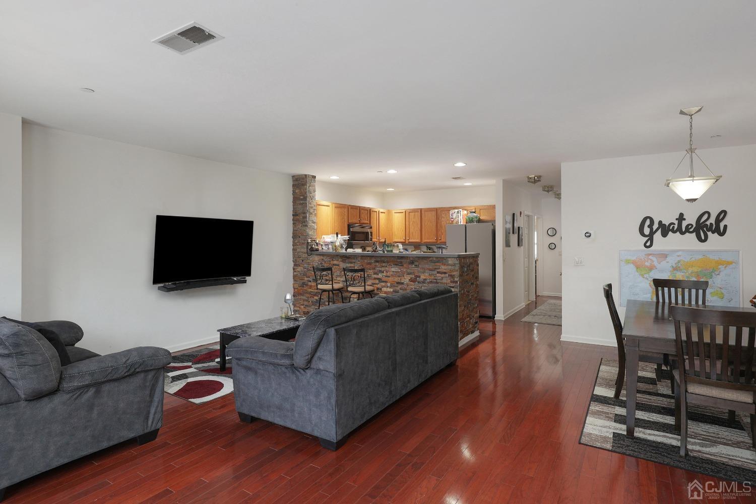 368 Rector Street, Unit 417 Perth Amboy, NJ 08861 - Photo 7 of 27 a living room with furniture and a flat screen tv