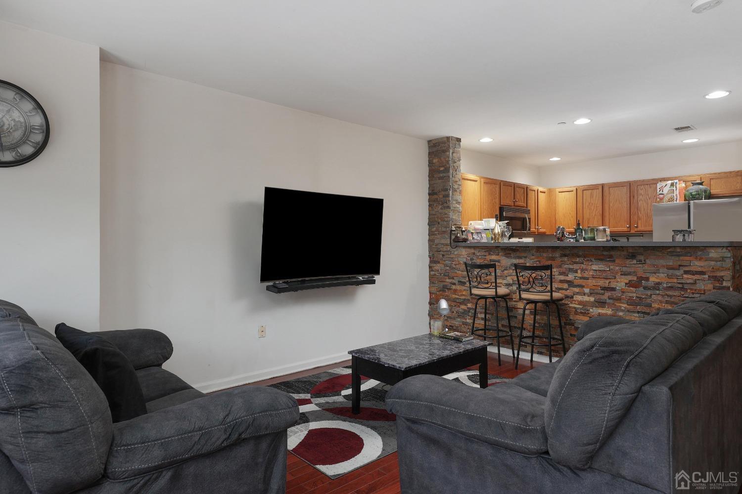 368 Rector Street, Unit 417 Perth Amboy, NJ 08861 - Photo 8 of 27 a living room with furniture and a flat screen tv