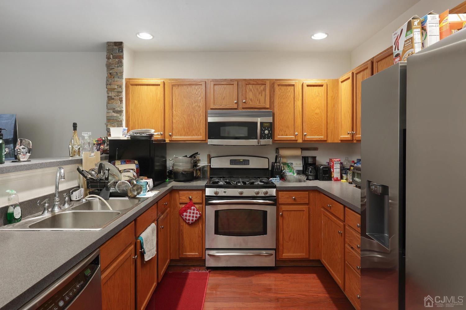 368 Rector Street, Unit 417 Perth Amboy, NJ 08861 - Photo 9 of 27 a kitchen with a sink stove and microwave