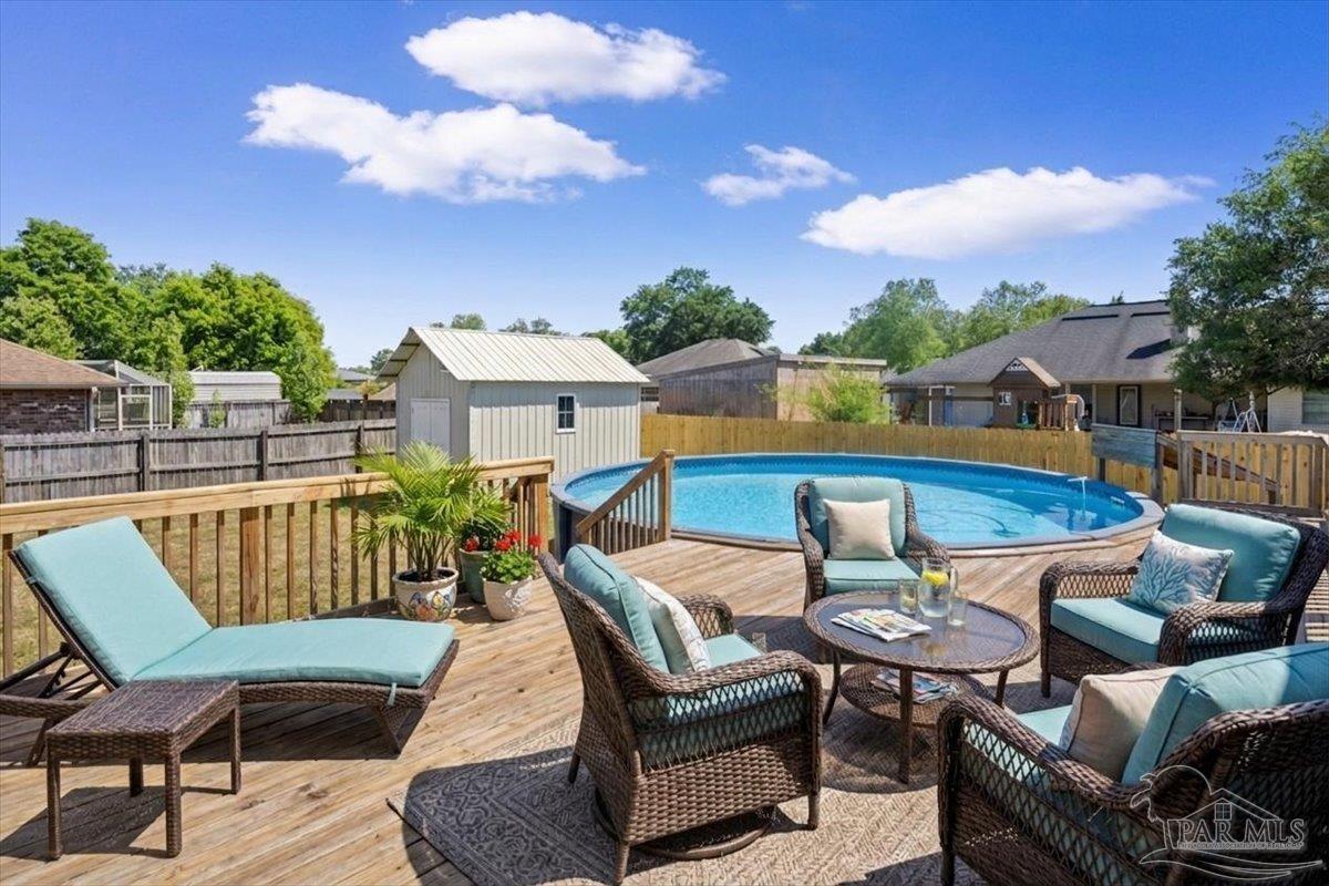 4015 Berry Circle Pace, FL 32571 - Photo 40 of 48 a view of a patio with swimming pool and furniture