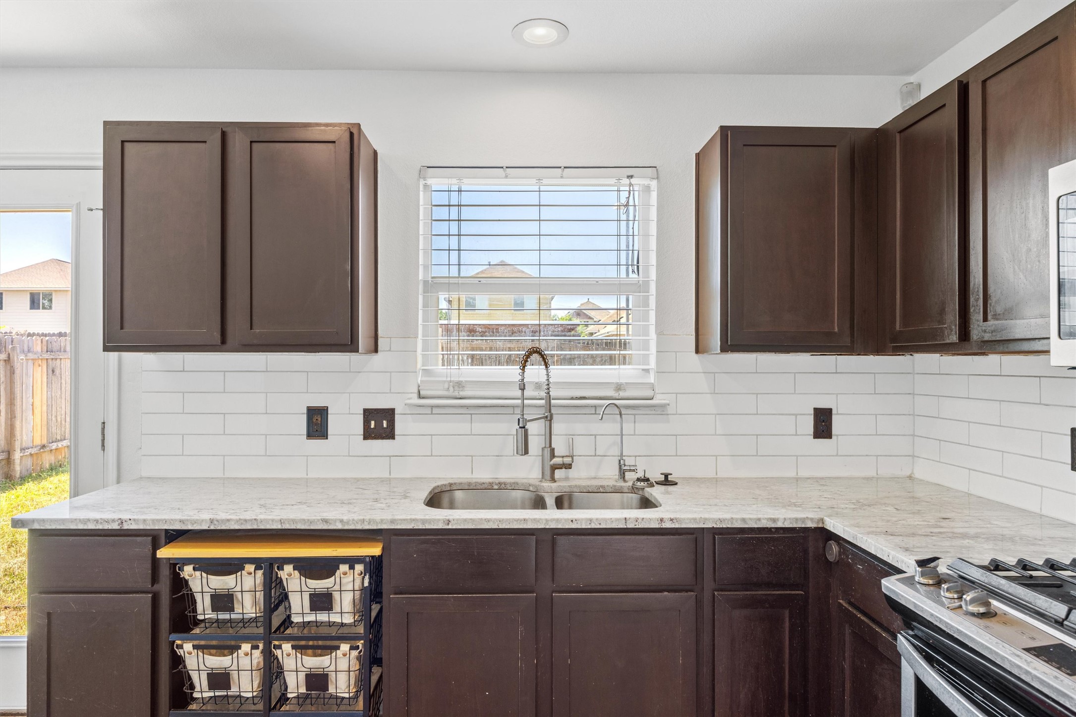 4516 Kind Way, Unit 253 Austin, TX 78725 - Photo 8 of 31 a kitchen with stainless steel appliances a sink stove and cabinets