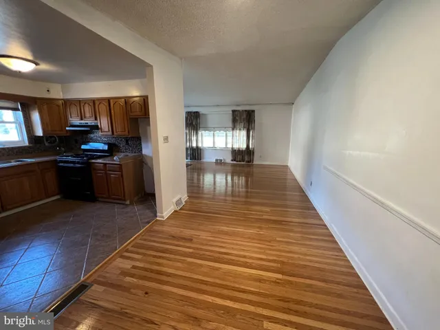 a view of a kitchen with a stove cabinets and wooden floor