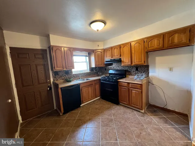 a kitchen with a sink stove and refrigerator