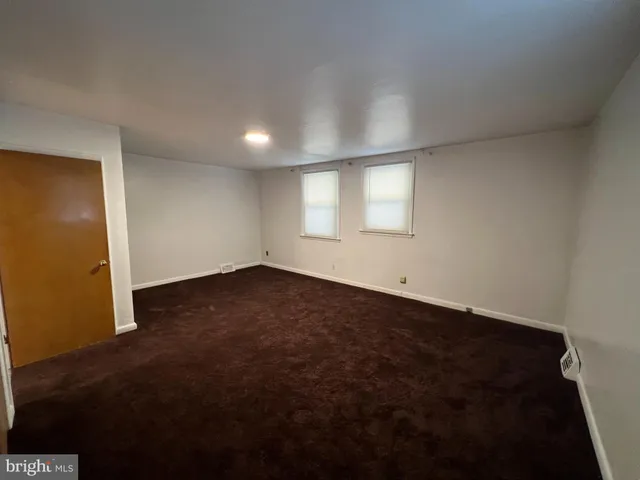 an empty room with a empty space and windows