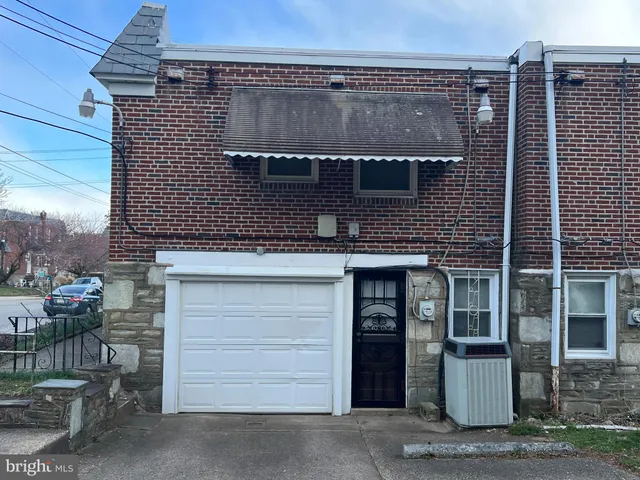 a front view of a house with a garage