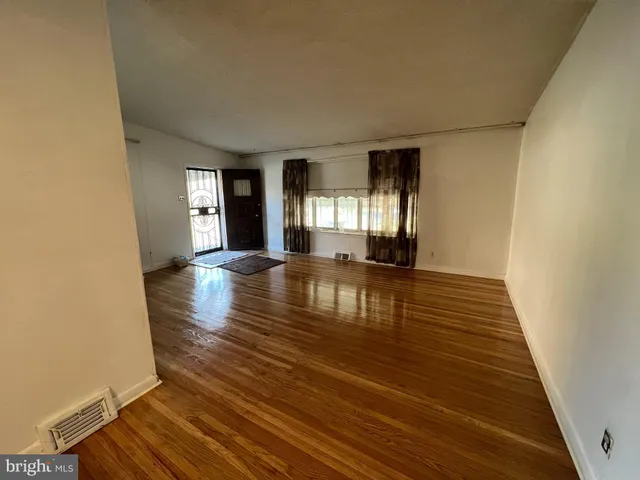 a view of a room with wooden floor