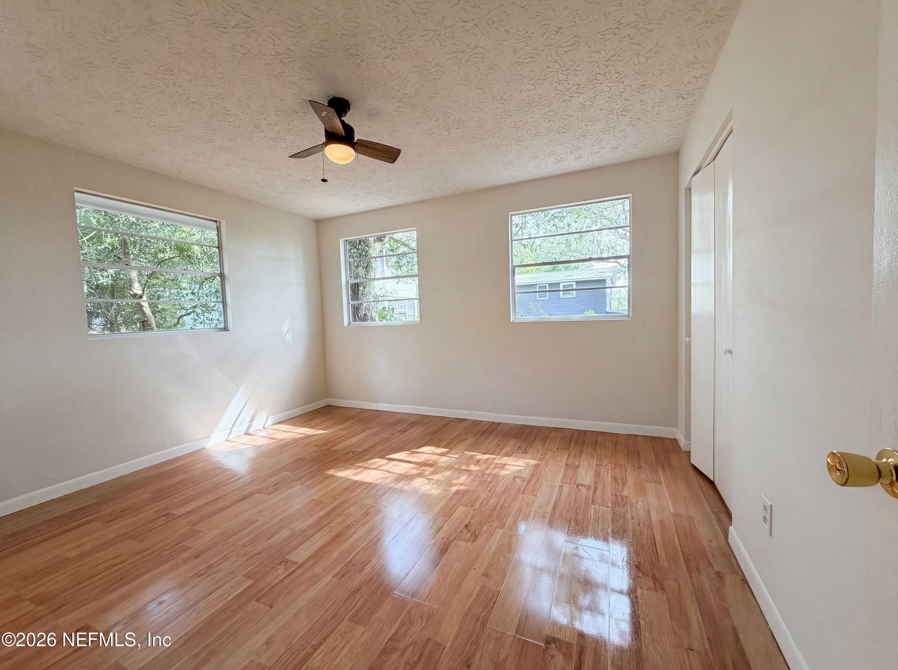 6917 Gatorbone Road Keystone Heights, FL 32656 - Photo 15 of 24 a view of an empty room with wooden floor and a window